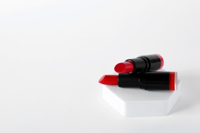 Photo of Beautiful lipsticks on white background, space for text