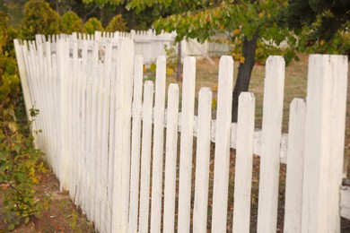 Photo of Beautiful white wooden fence outdoors on sunny day