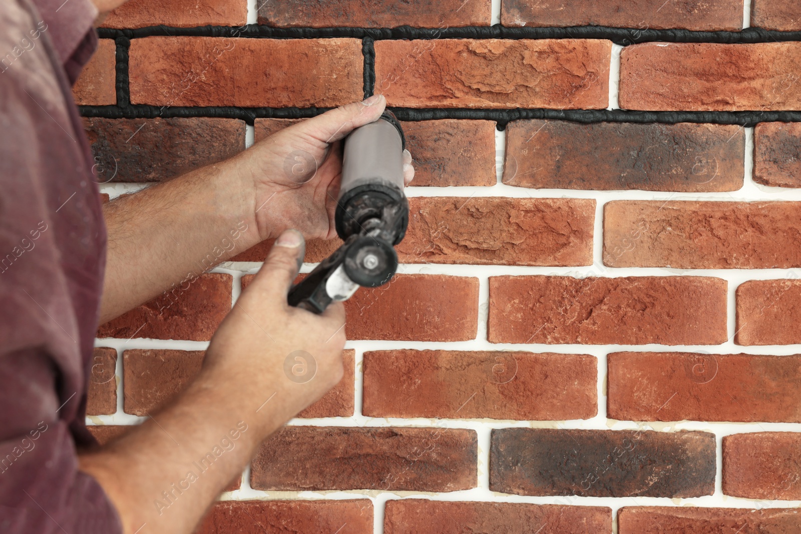 Photo of Professional builder using tiling fugue for grouting, closeup