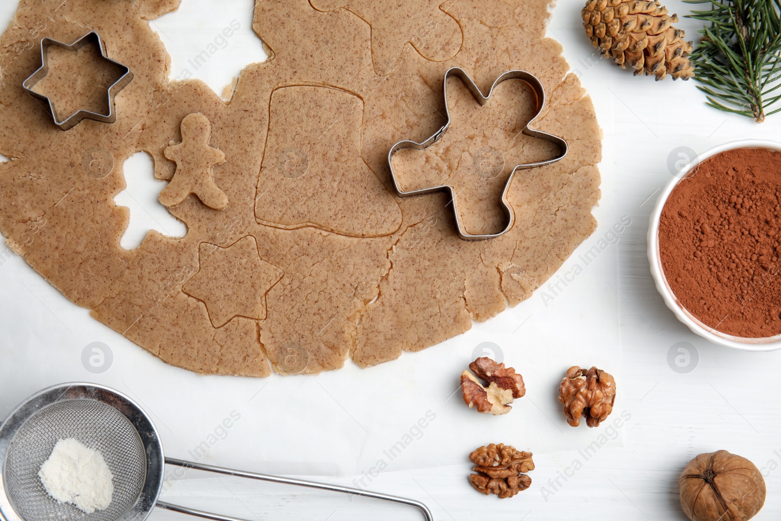 Photo of Homemade Christmas cookies. Flat lay composition with dough on white table