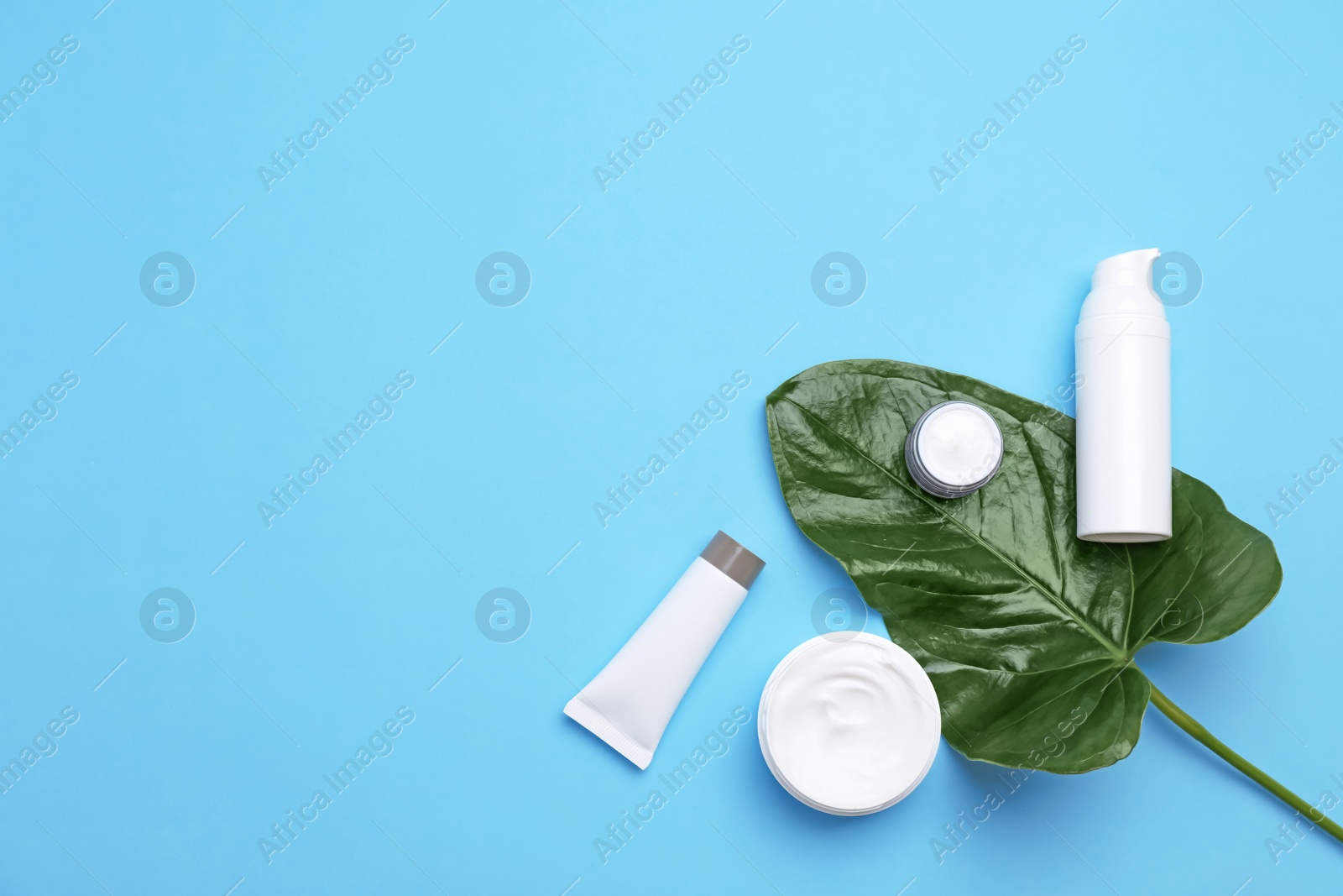 Photo of Flat lay composition with cosmetic products on color background