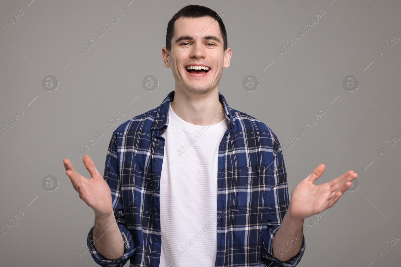 Photo of Portrait of surprised man on grey background