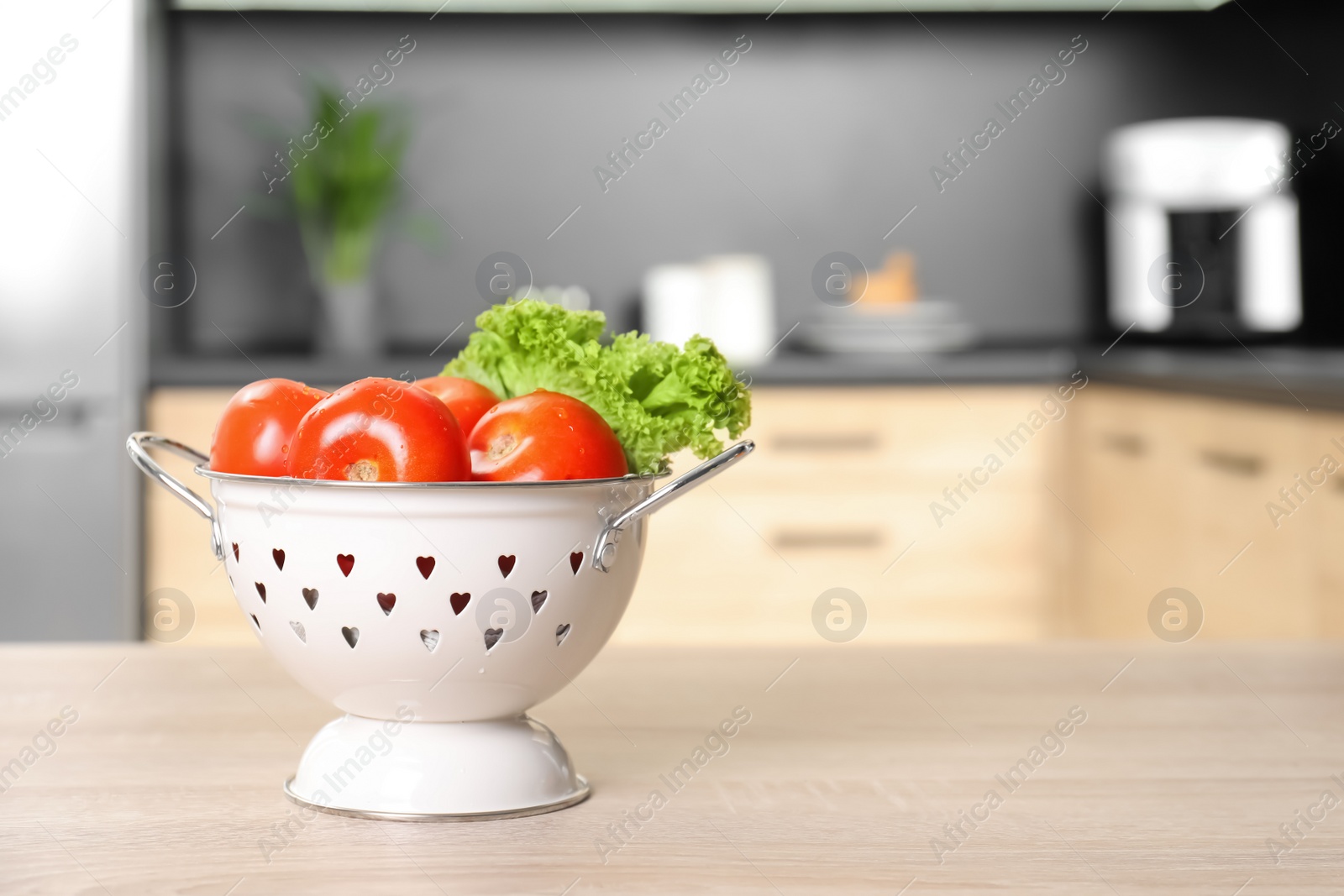 Photo of Fresh vegetables on wooden table in kitchen. Space for text