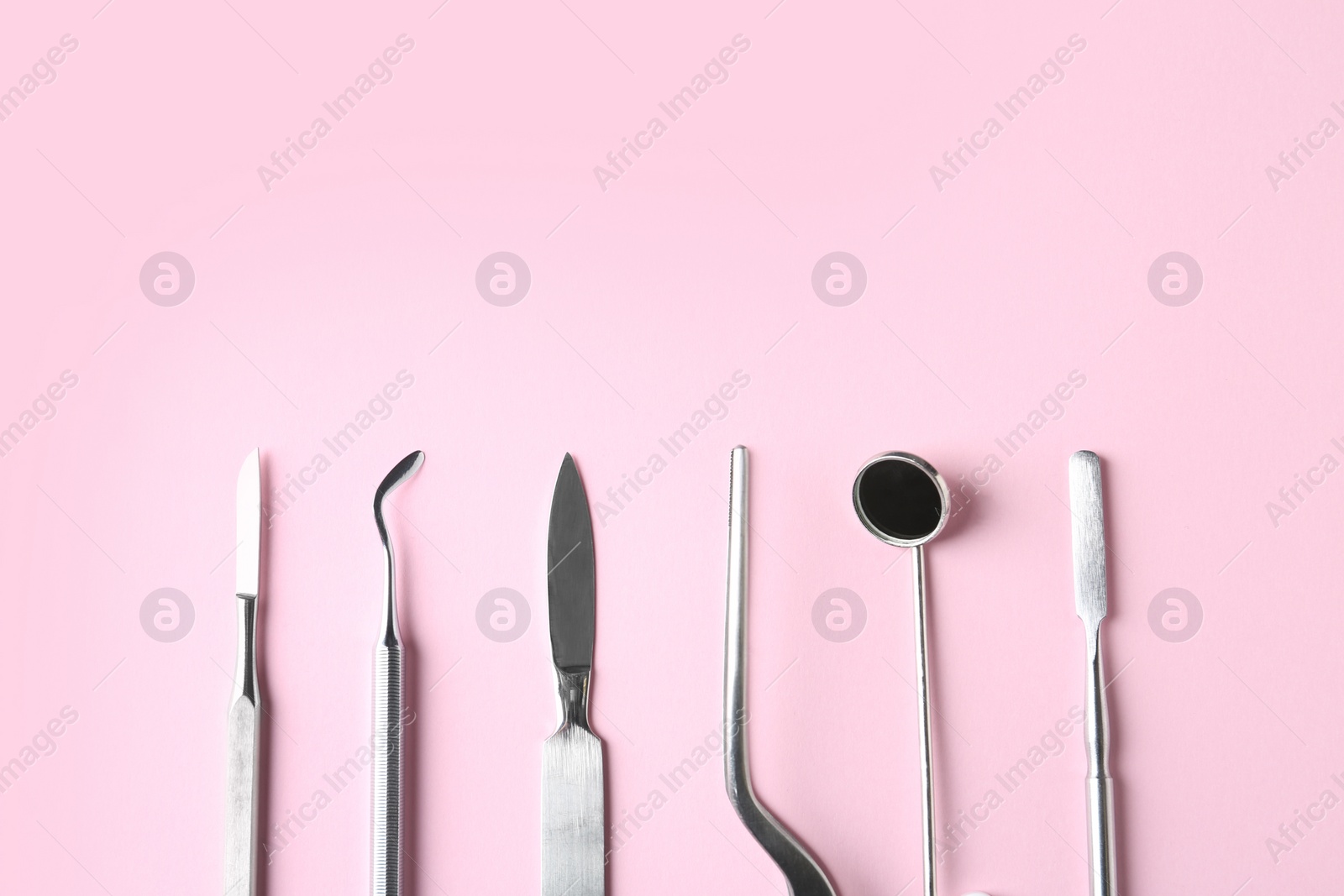 Photo of Professional dental tools and space for text on color background, flat lay. Mouth and teeth care