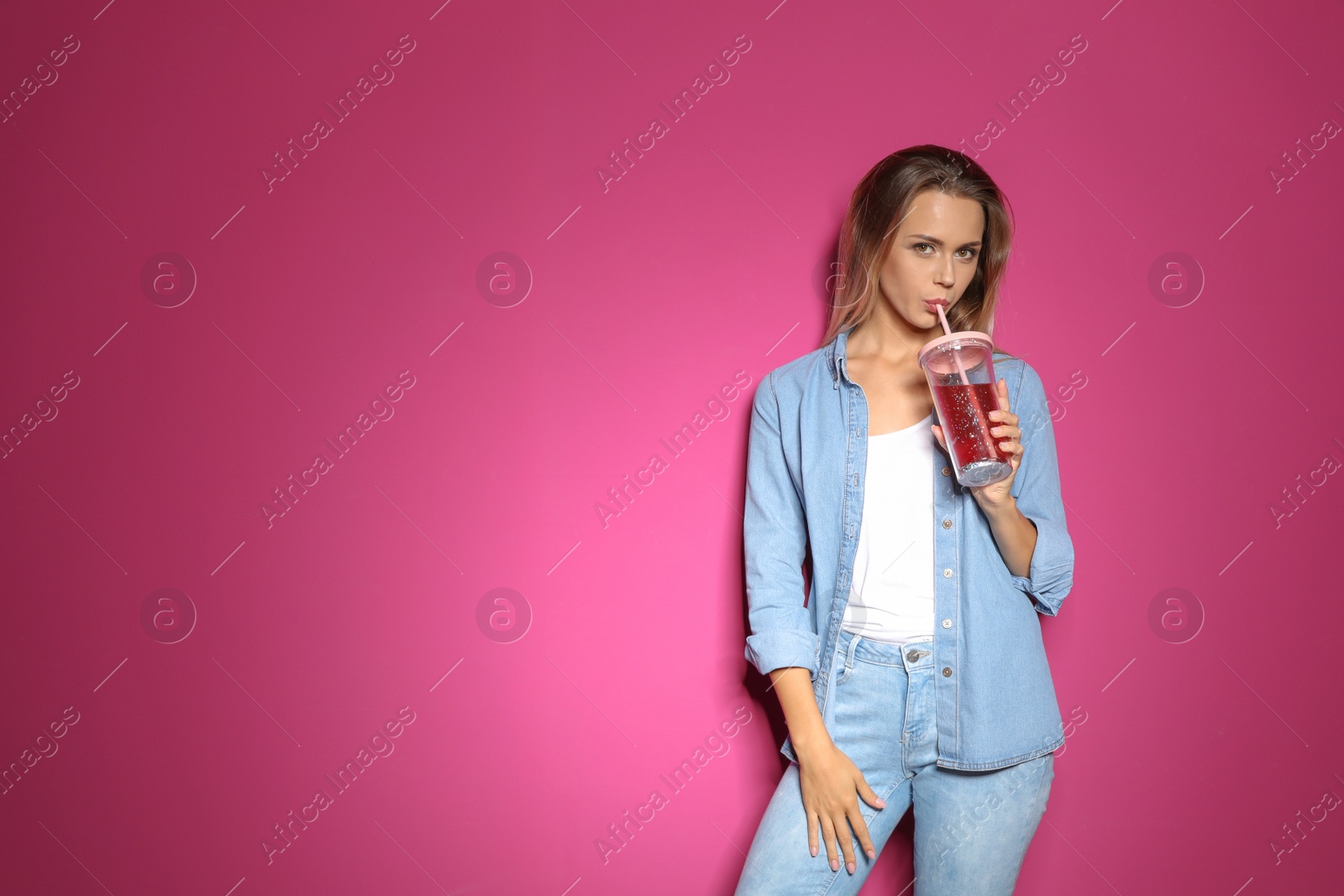 Photo of Portrait of beautiful woman with tasty drink on color background