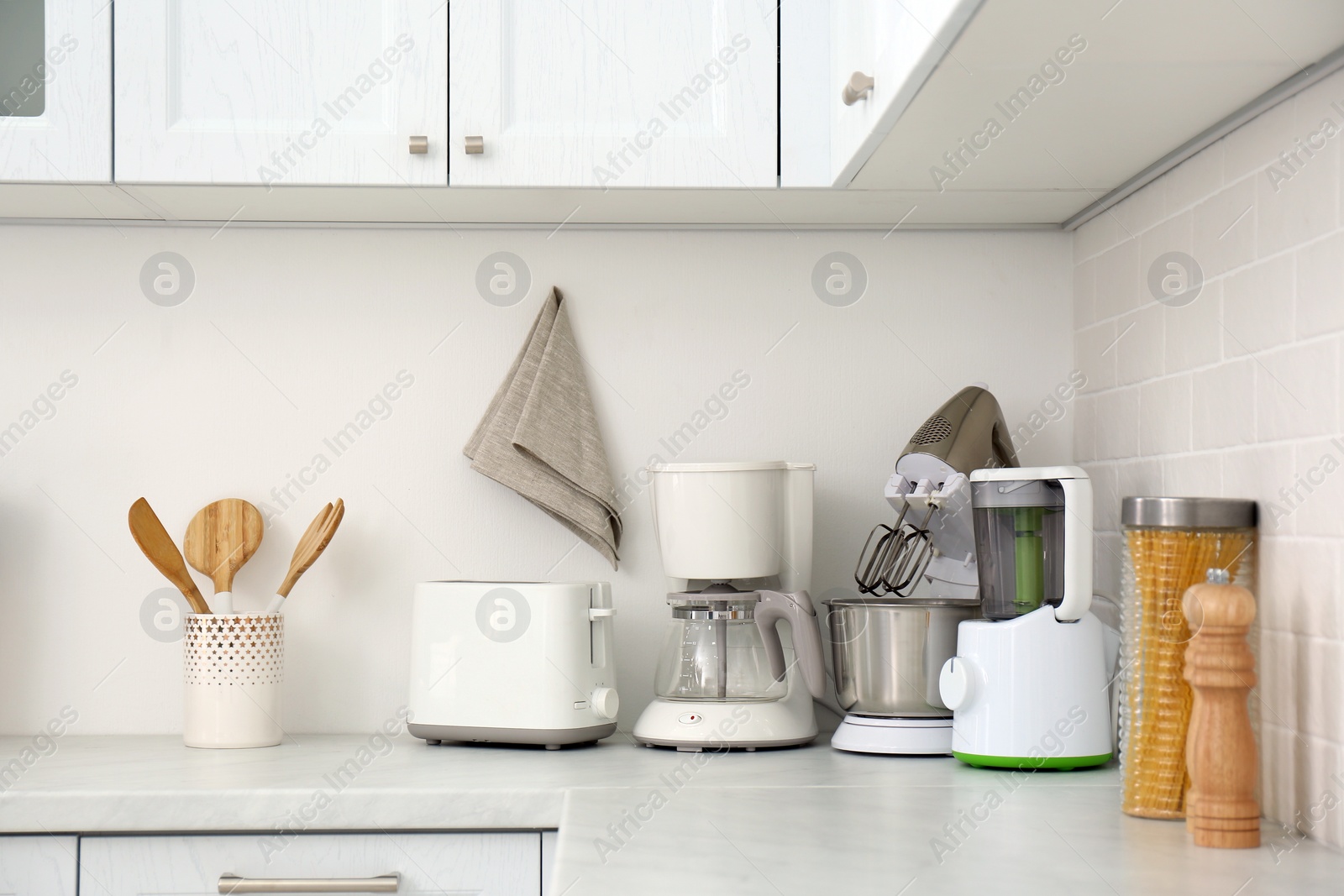 Photo of Modern toaster and other home appliances on countertop in kitchen