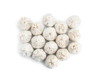 Photo of Many uncooked khinkali (dumplings) isolated on white, top view. Georgian cuisine