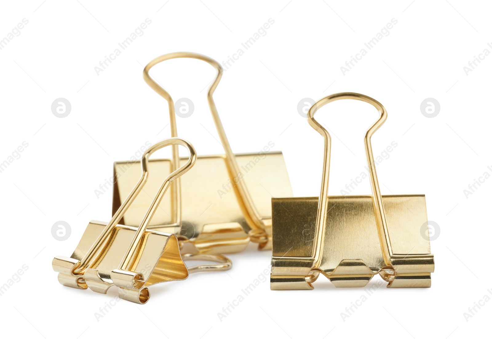 Photo of Golden binder clips on white background. Stationery item