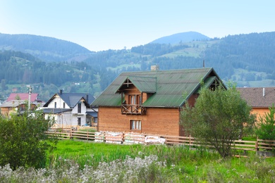 Picturesque view of village and forest on mountain slopes