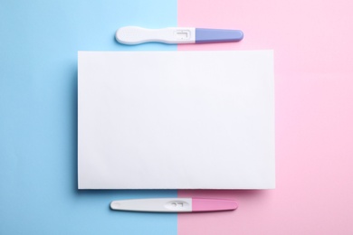 Photo of Different pregnancy tests and blank card on color background, flat lay. Space for text