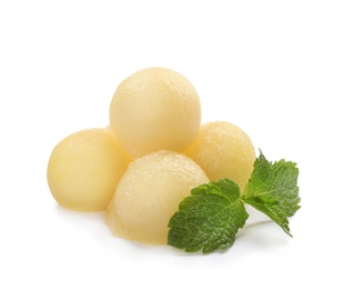 Melon balls and mint on white background