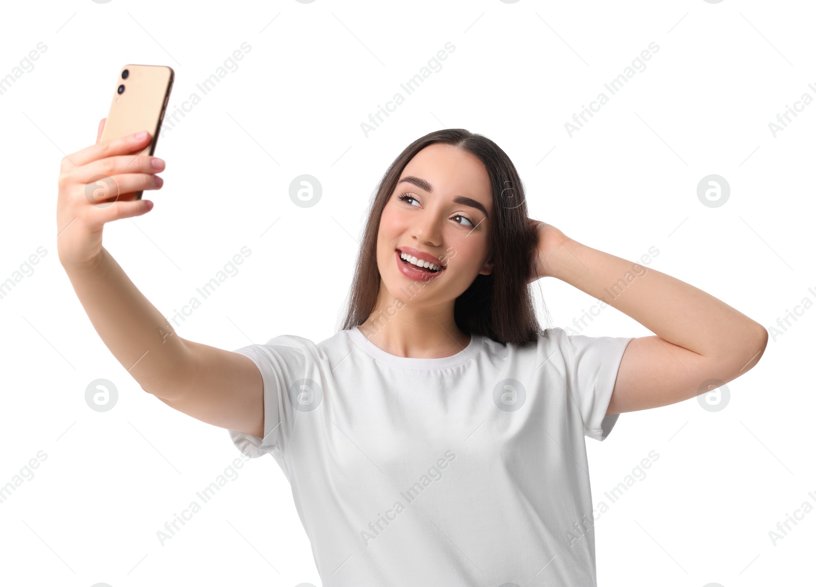 Photo of Smiling young woman taking selfie with smartphone on white background