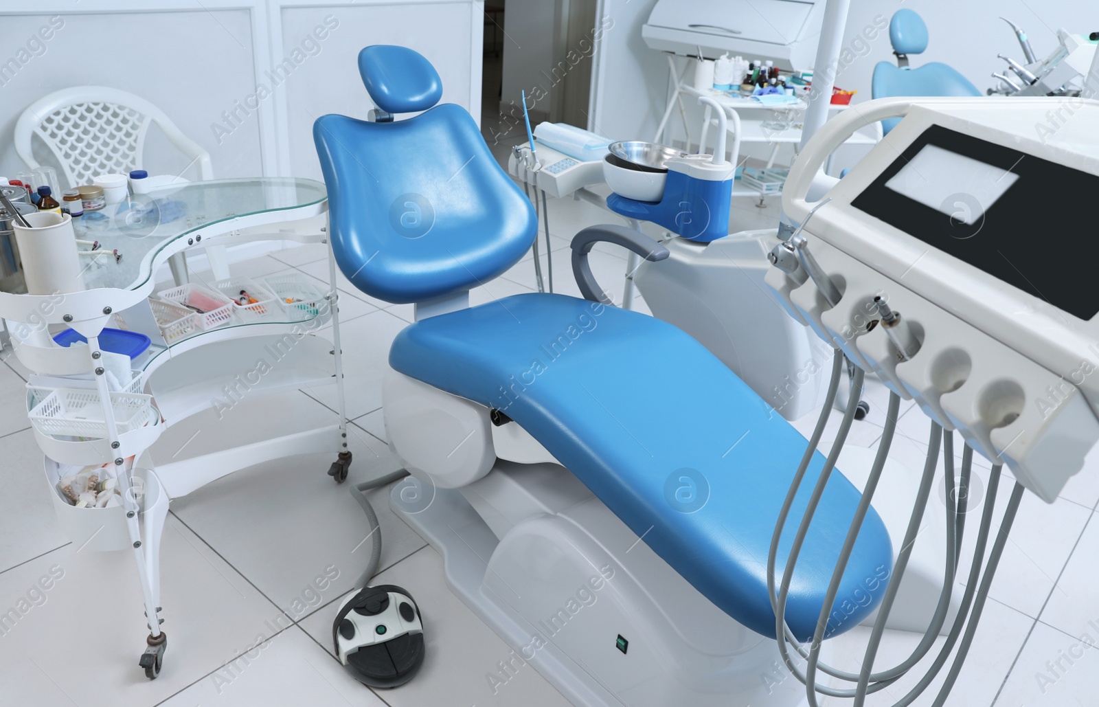 Photo of Dentist's office interior with chair and modern equipment