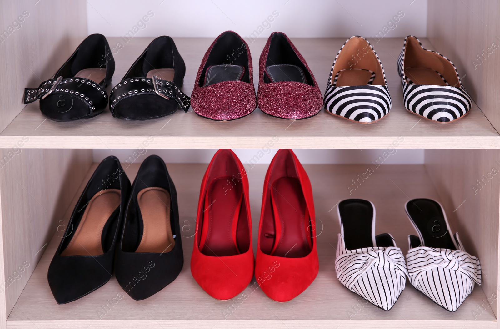 Photo of Wardrobe shelves with different stylish shoes