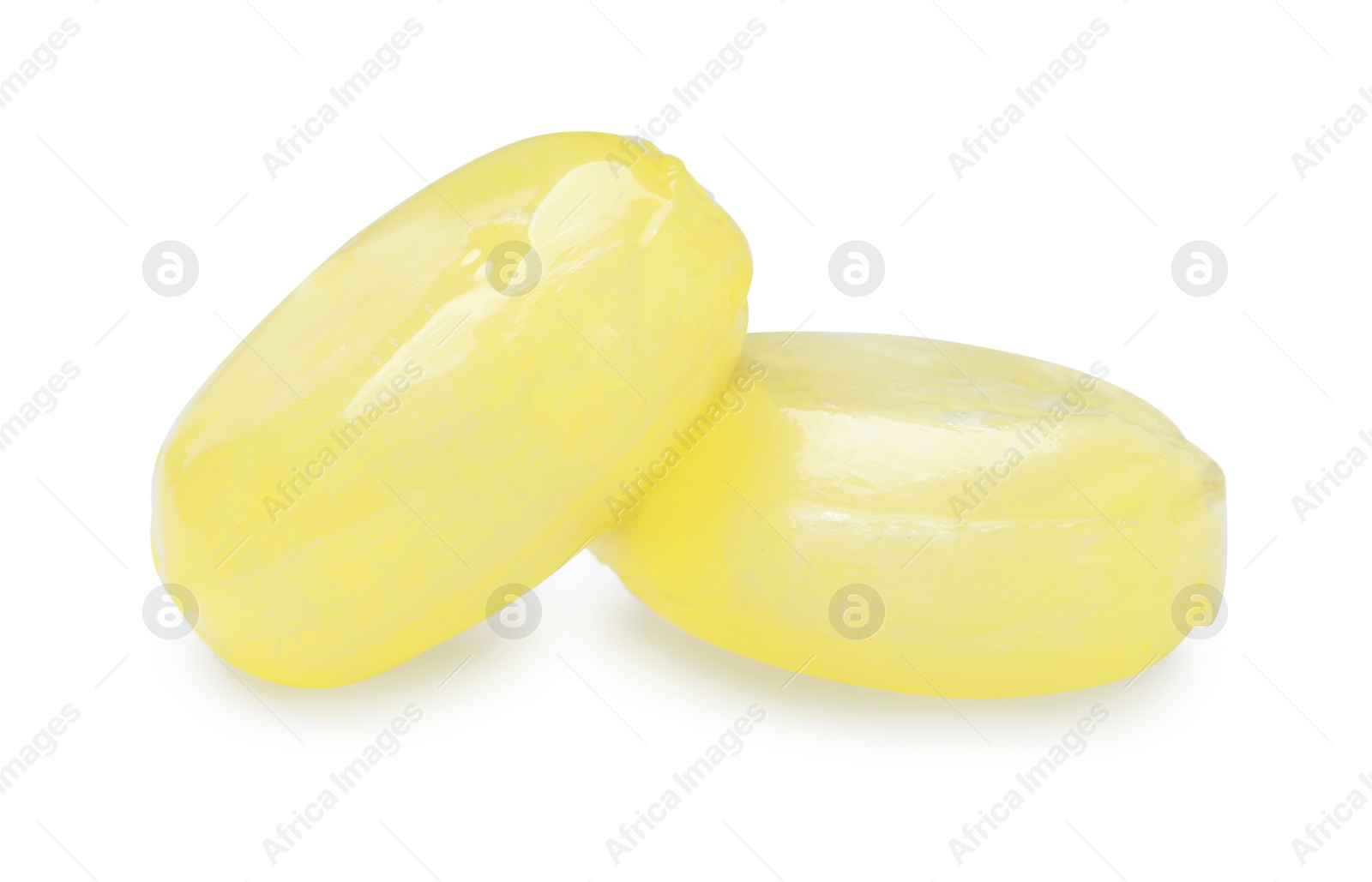 Photo of Tasty small lemon drops isolated on white