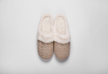 Photo of Pair of beautiful soft slippers on white background, top view