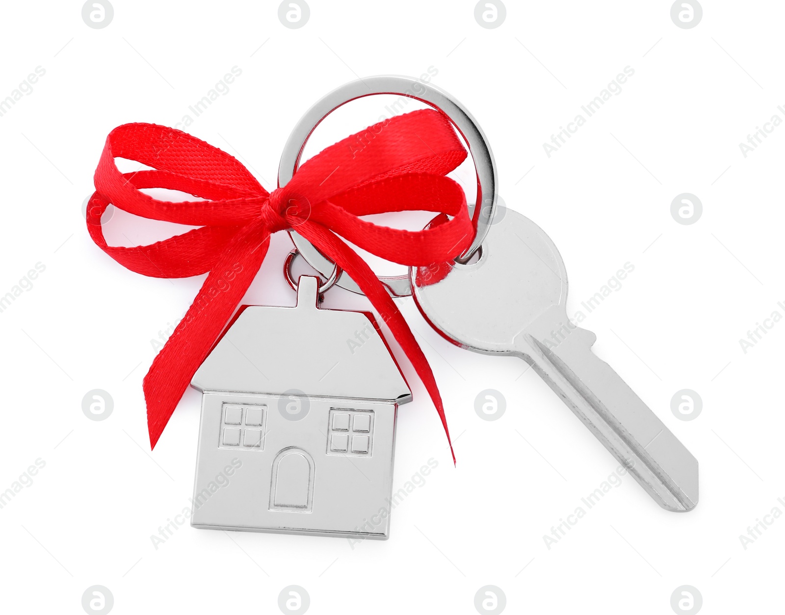 Photo of Key with keychain in shape of house and red bow isolated on white, top view