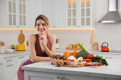 Photo of Woman with healthy food in kitchen. Keto diet