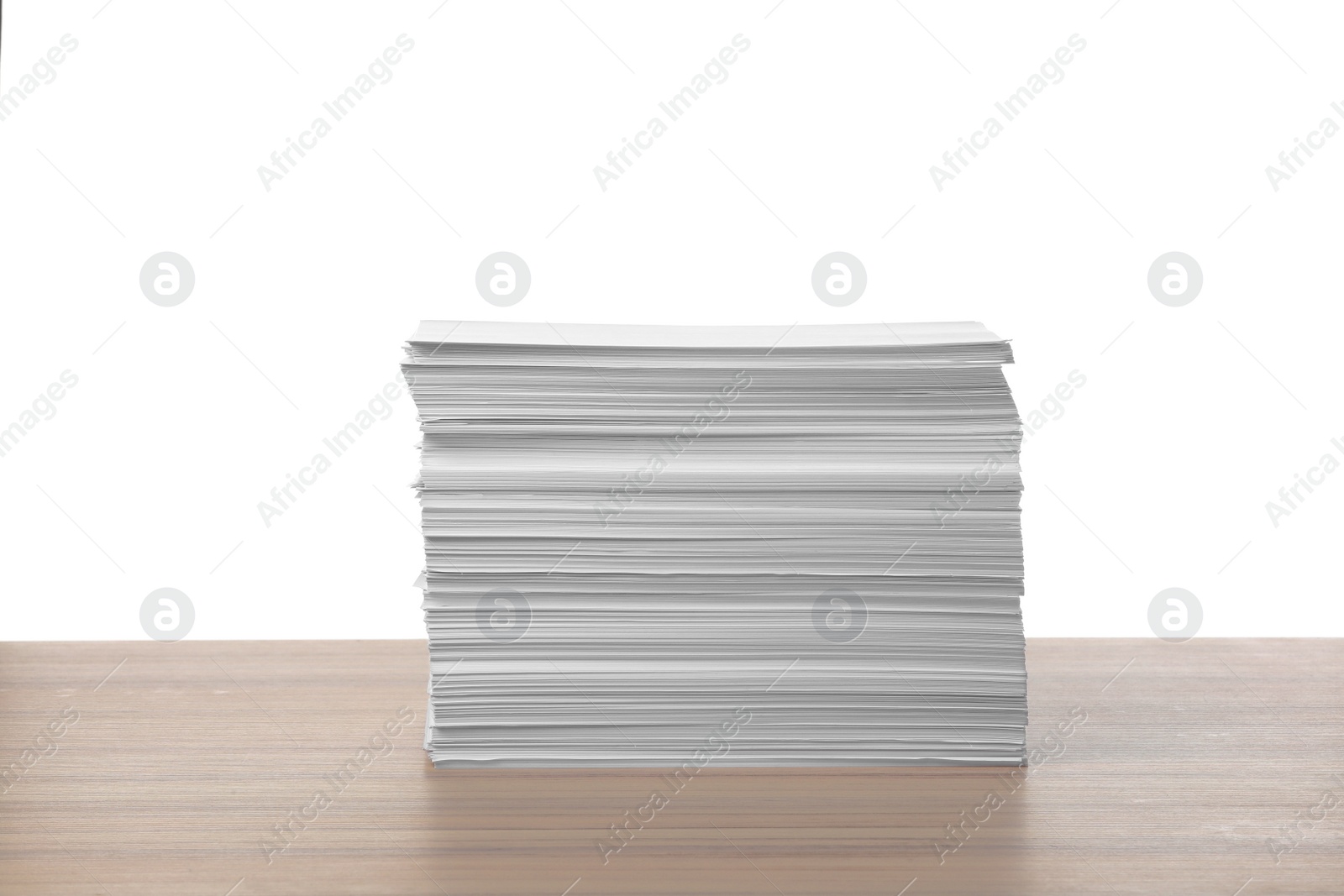 Photo of Stack of paper sheets on wooden table against white background