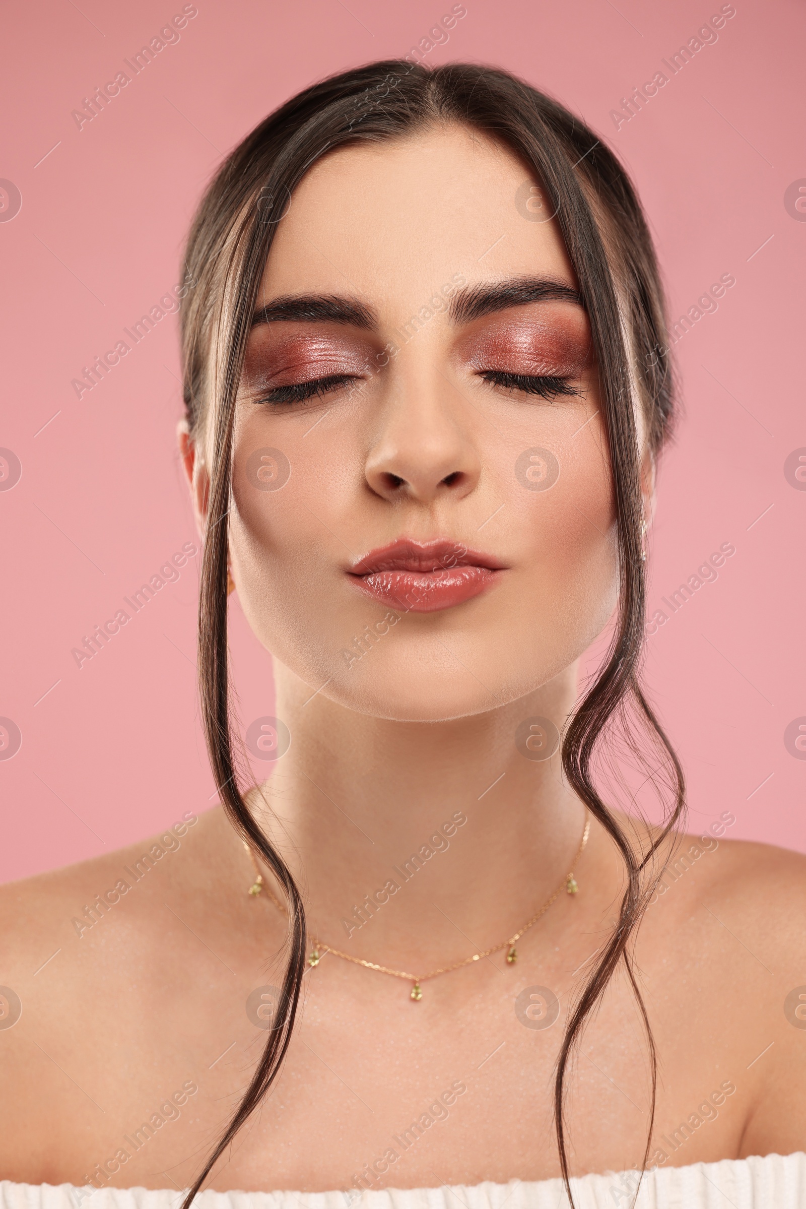 Photo of Beautiful woman with elegant necklace on pink background