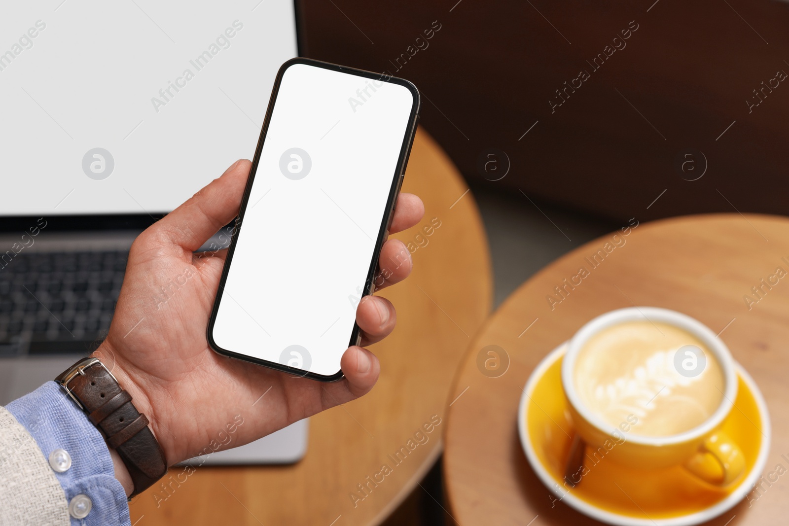 Photo of Man using his smartphone in cafe, closeup