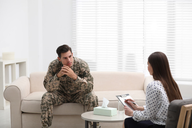 Psychotherapist working with male military officer in office