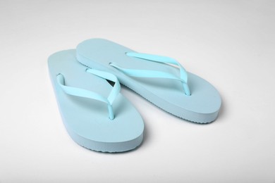 Photo of Pair of stylish flip flops on white background