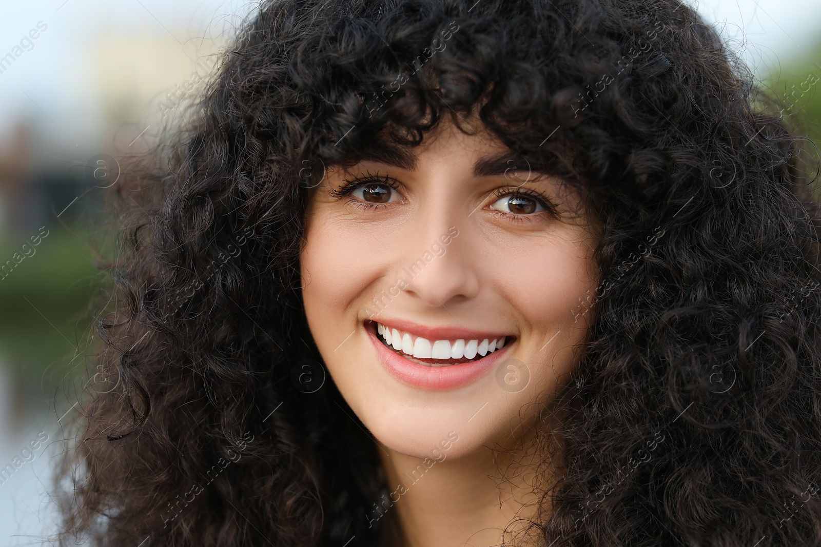 Photo of Portrait of beautiful woman outdoors. Attractive lady smiling and looking into camera