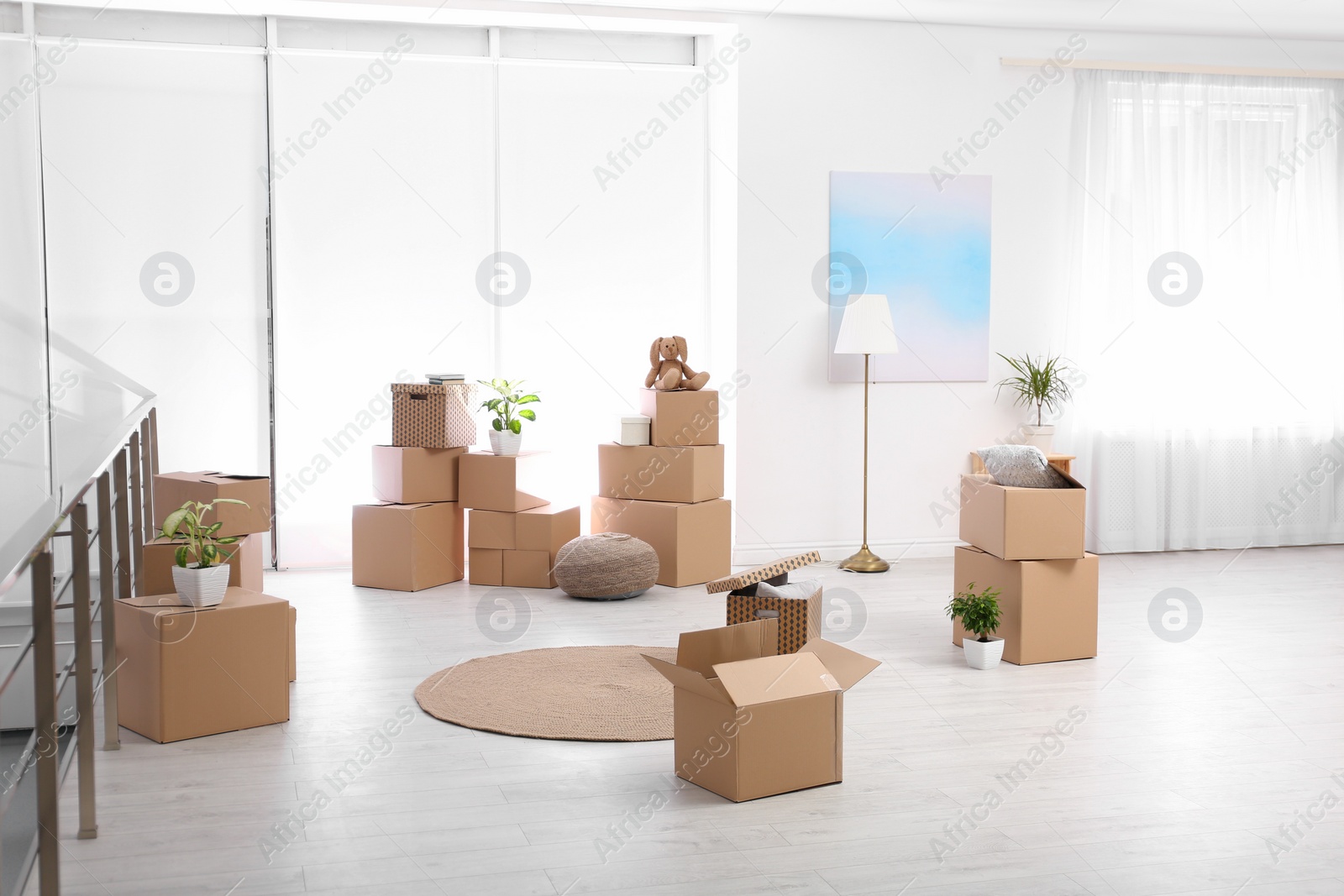 Photo of Room interior with moving boxes and belongings