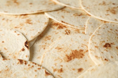 Photo of Many tasty homemade tortillas as background, closeup