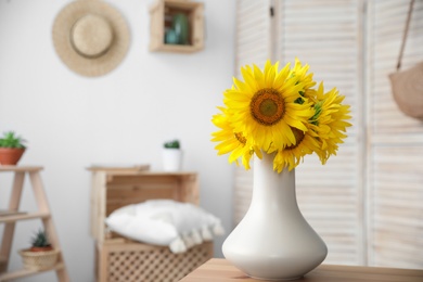 Photo of Bouquet of beautiful sunflowers on table indoors. Space for text