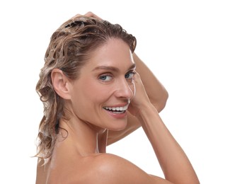 Beautiful happy woman washing hair on white background