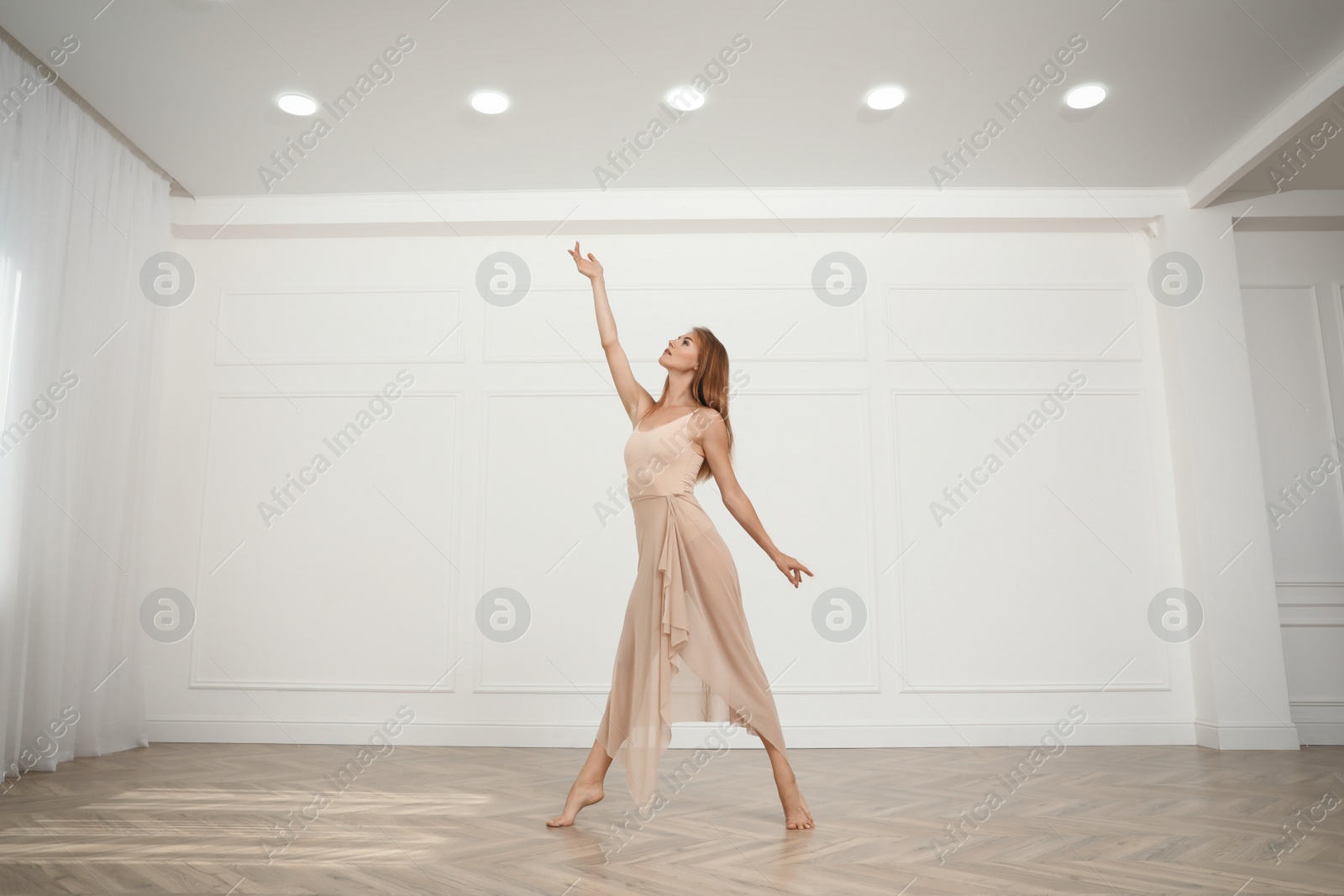 Photo of Beautiful professional dancer practicing moves in studio