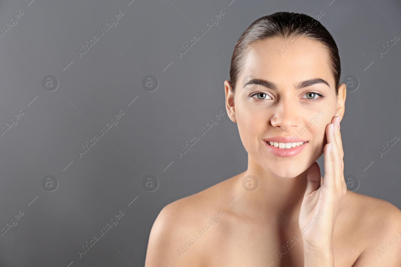 Photo of Portrait of beautiful young woman and space for text on grey background. Cosmetic surgery concept