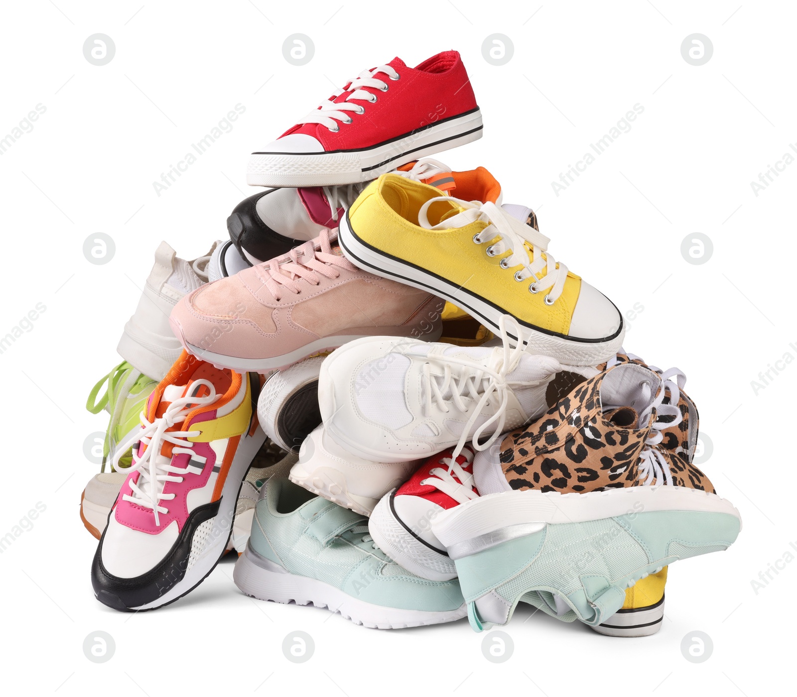 Photo of Pile of different female sneakers isolated on white