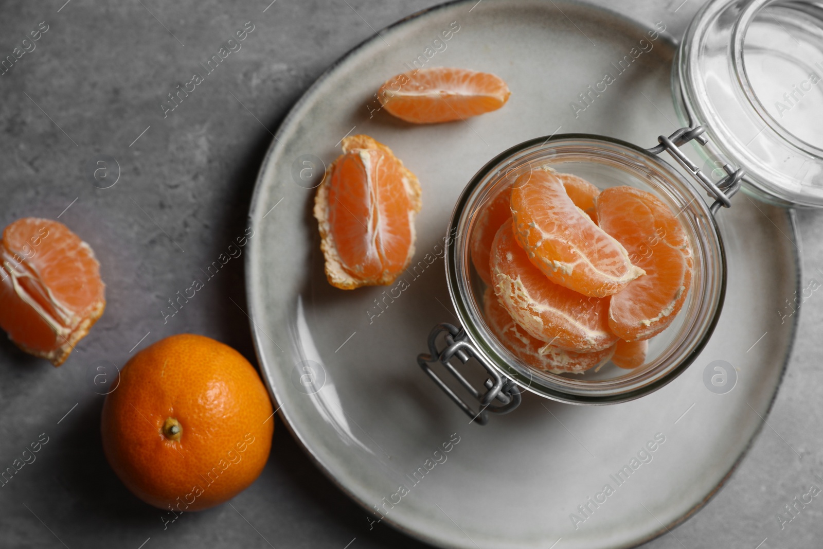 Photo of Fresh ripe tangerines on grey table, flat lay