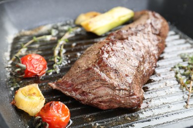 Photo of Delicious grilled beef meat and vegetables in pan, closeup