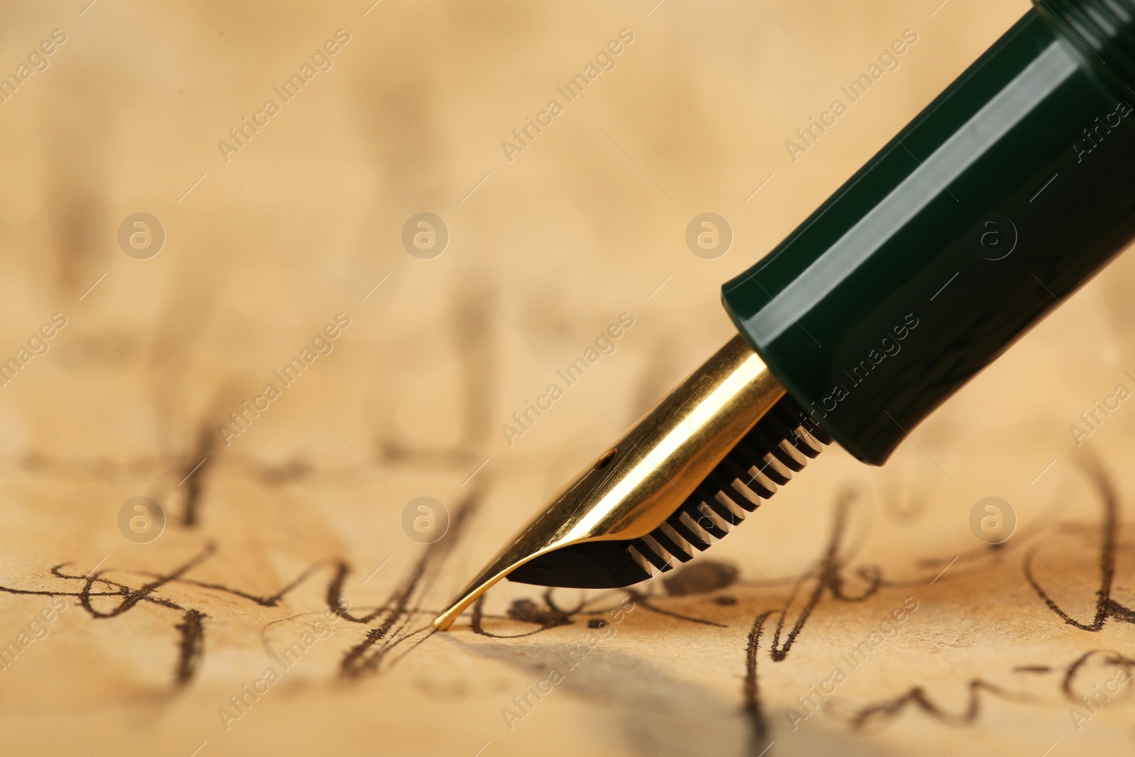 Photo of Writing letter with beautiful fountain pen, closeup