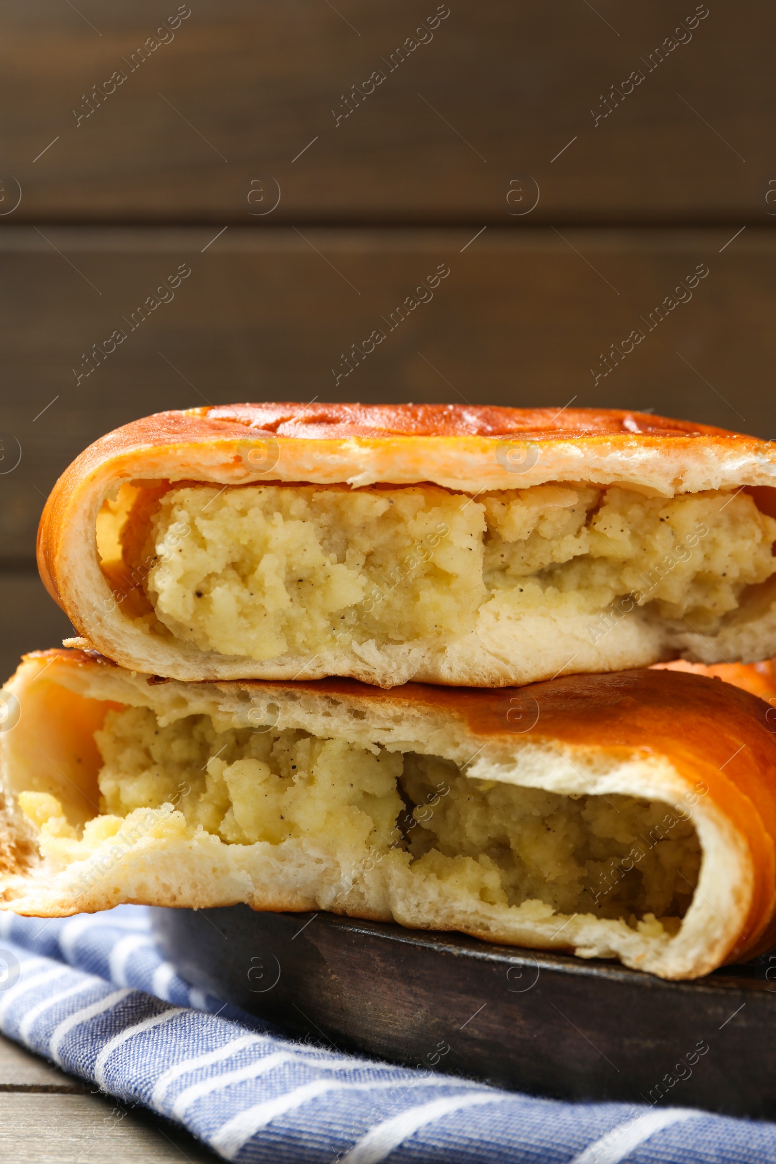 Photo of Delicious baked patties with potato on wooden table, closeup