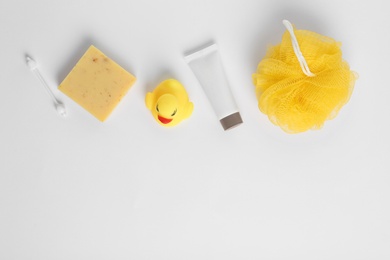 Composition with baby cosmetic products on white background, top view