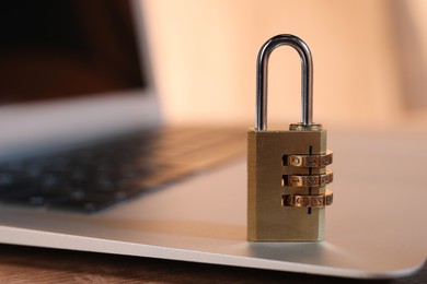 Photo of Cyber security. Laptop with padlock on table, closeup and space for text