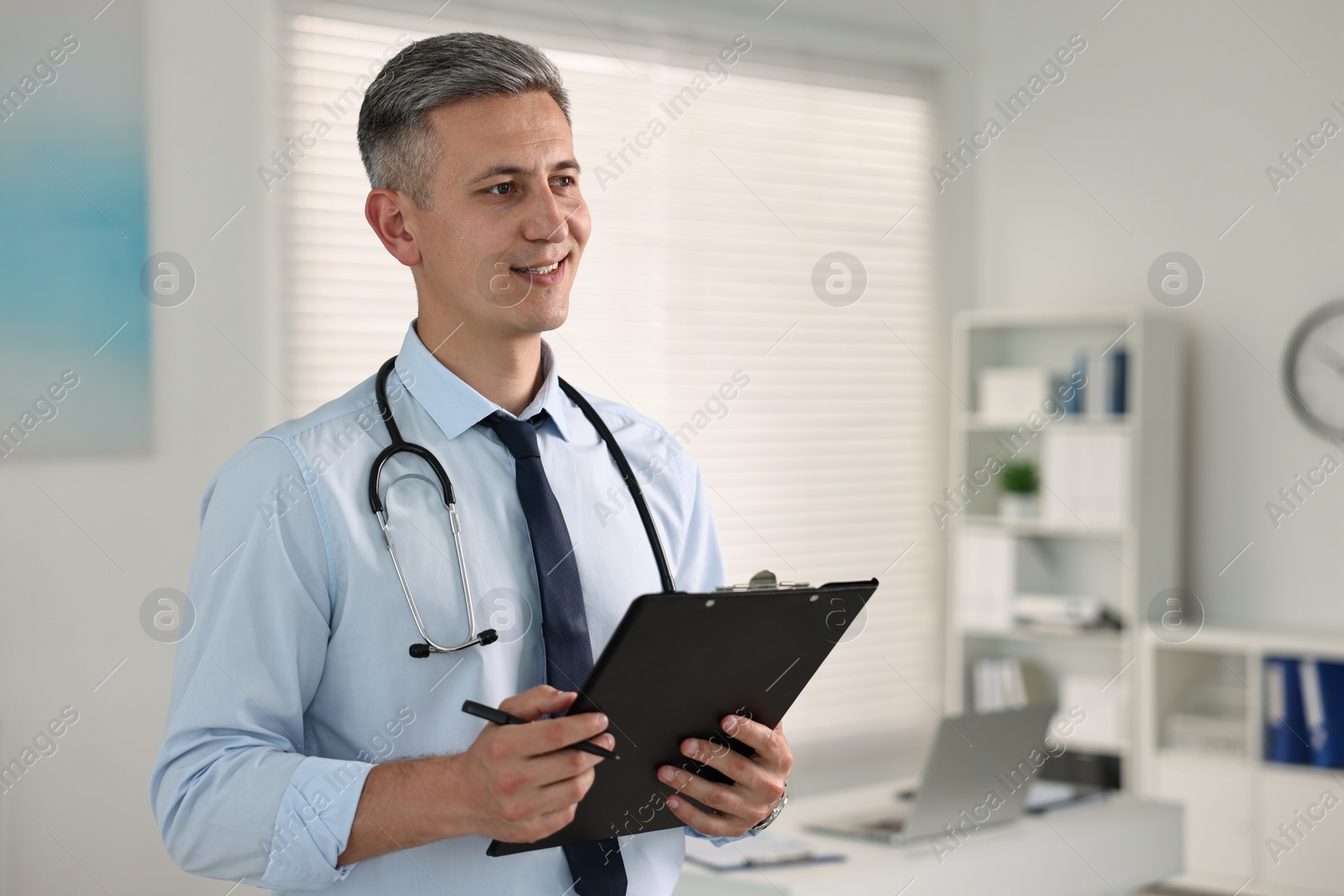 Photo of Doctor with stethoscope and clipboard in clinic, space for text
