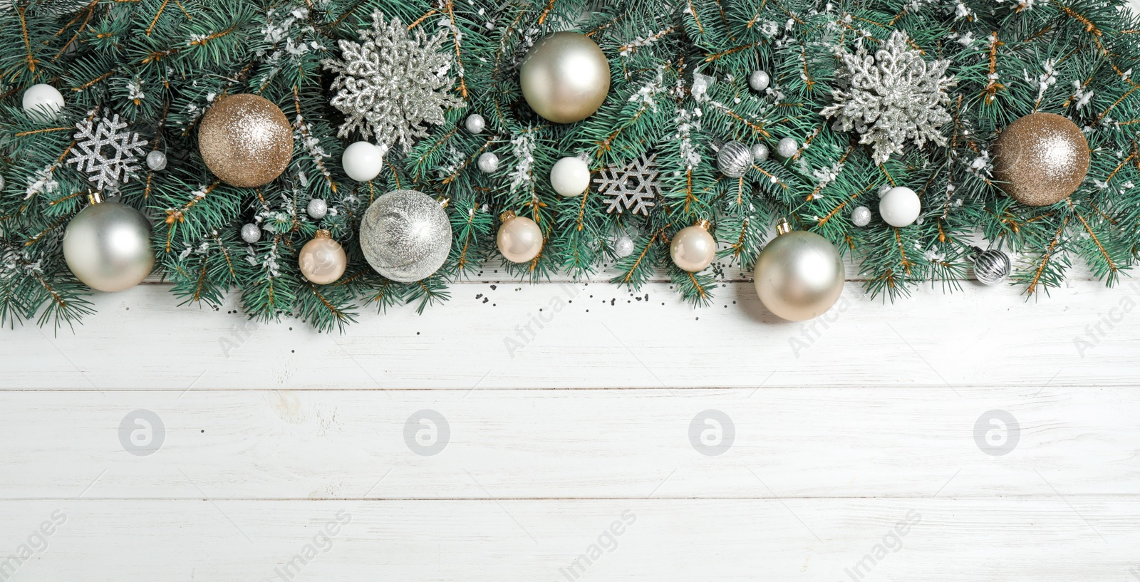 Photo of Fir tree branches with Christmas decoration on white wooden background, flat lay. Space for text