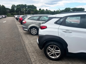 Photo of View of many different cars parked near road