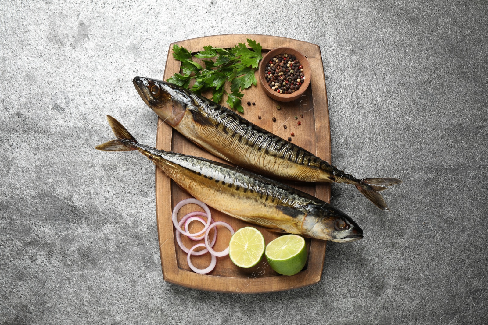 Photo of Tasty smoked fish on grey table, top view