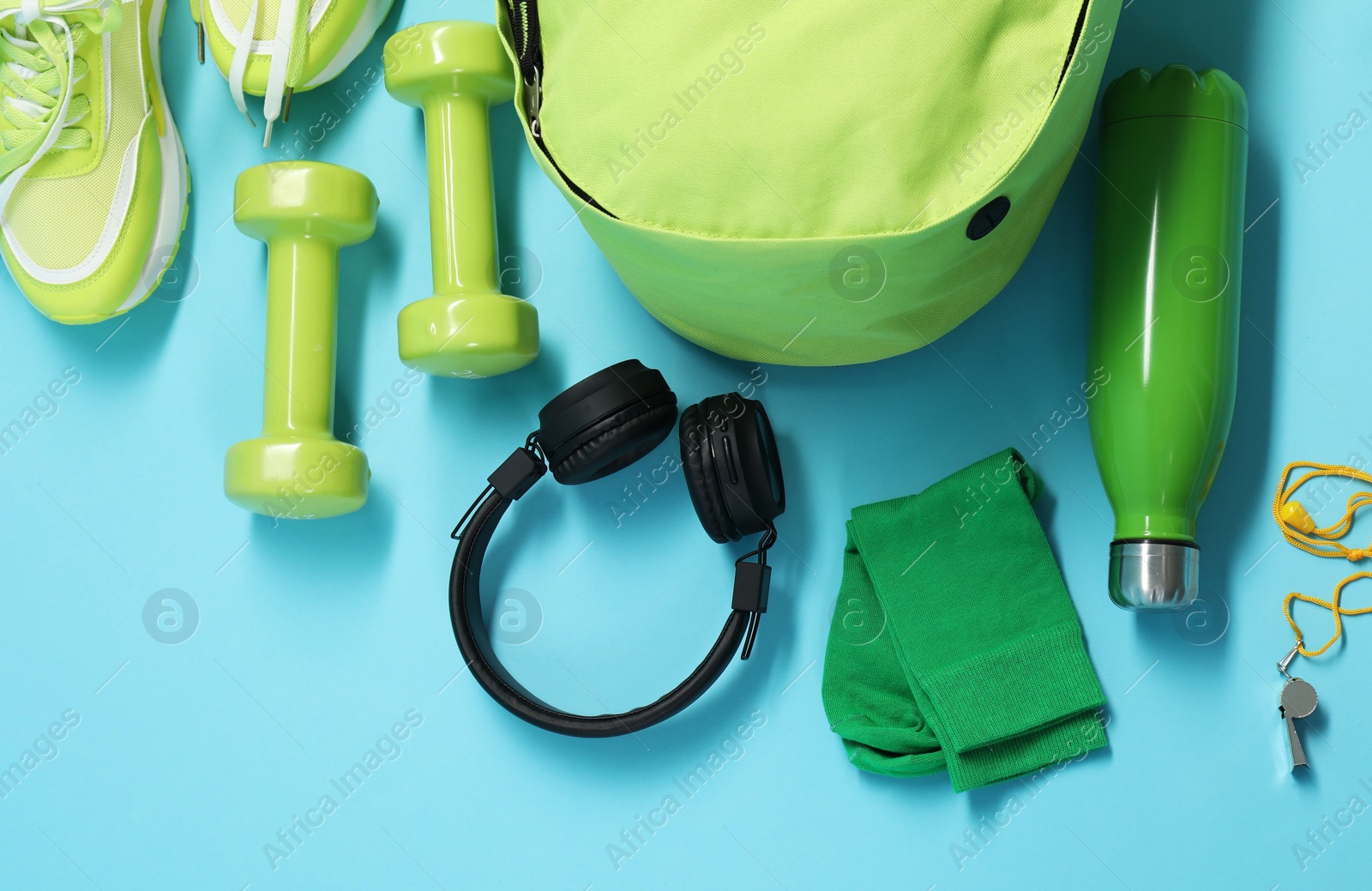 Photo of Different sports equipment on light blue background, flat lay