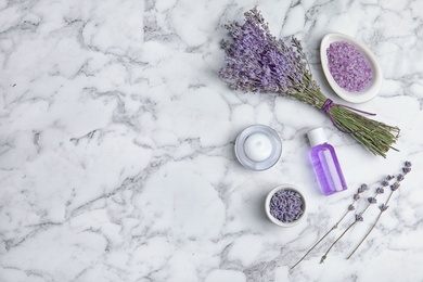 Photo of Flat lay composition with lavender flowers and natural cosmetic products on marble background