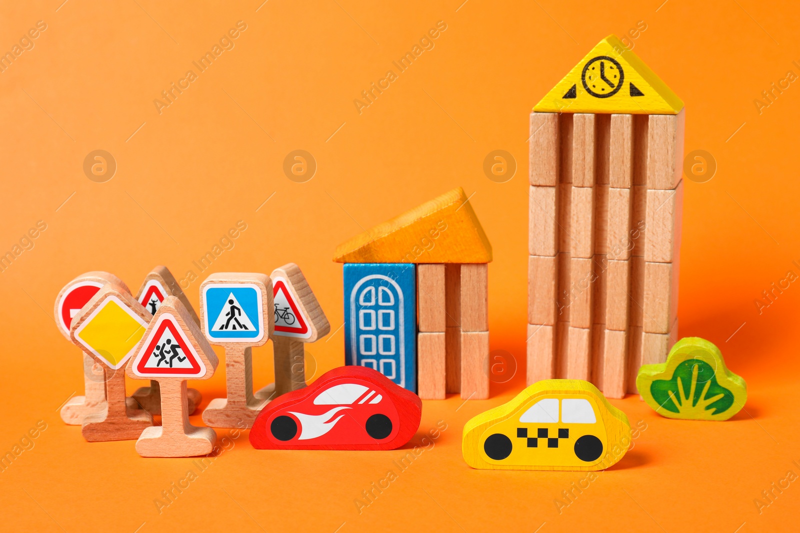 Photo of Set of wooden toys on orange background. Children's development