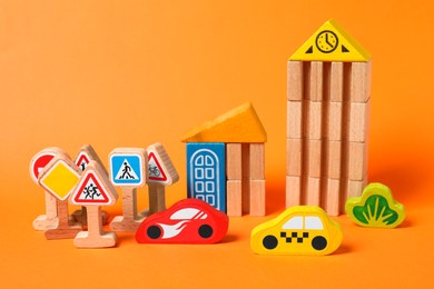 Set of wooden toys on orange background. Children's development