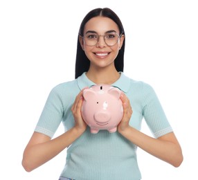 Happy young woman with piggy bank on white background